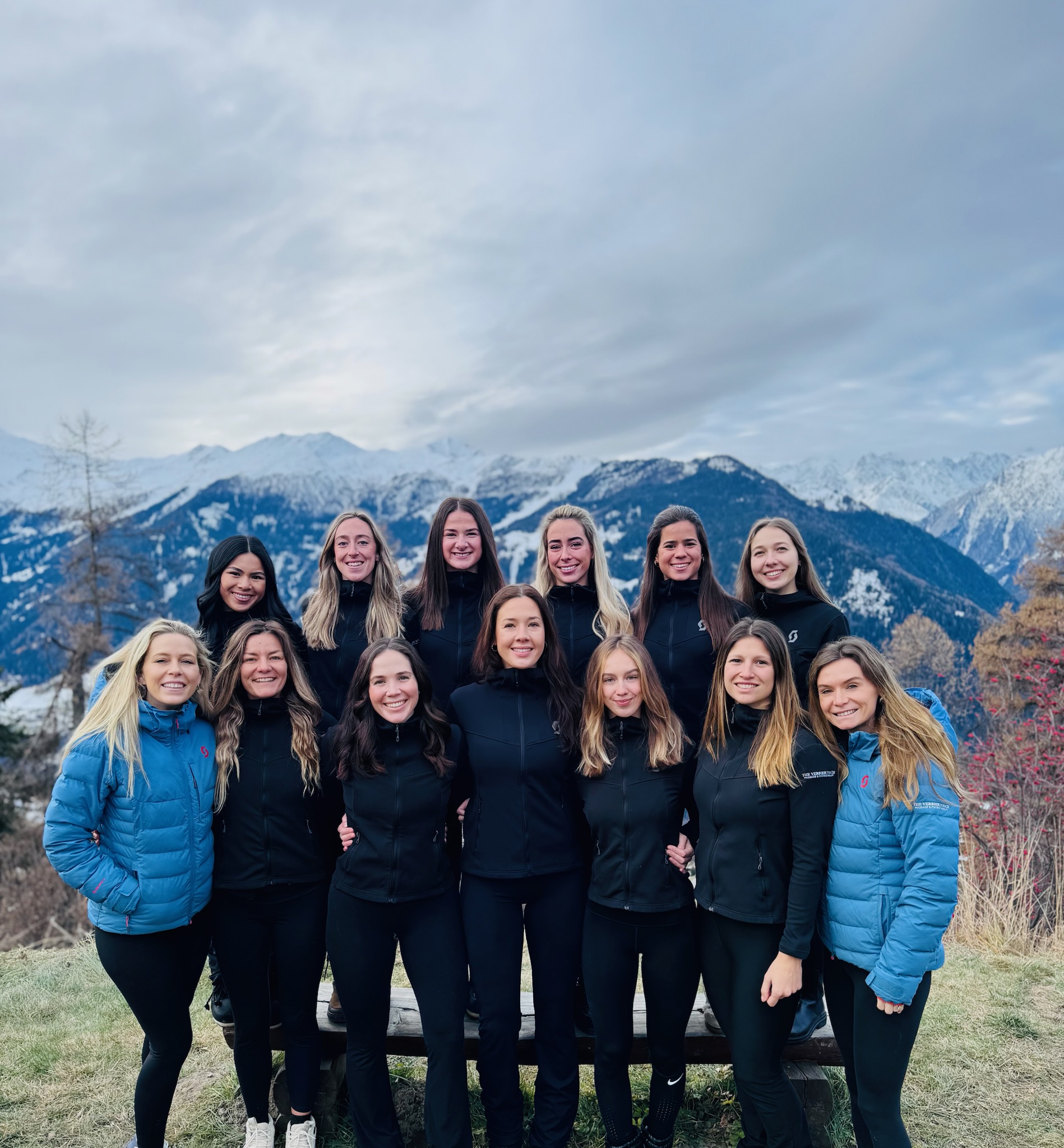 The Verbier Touch physiotherapy and massage team in Verbier, Switzerland, with the Swiss Alps behind them